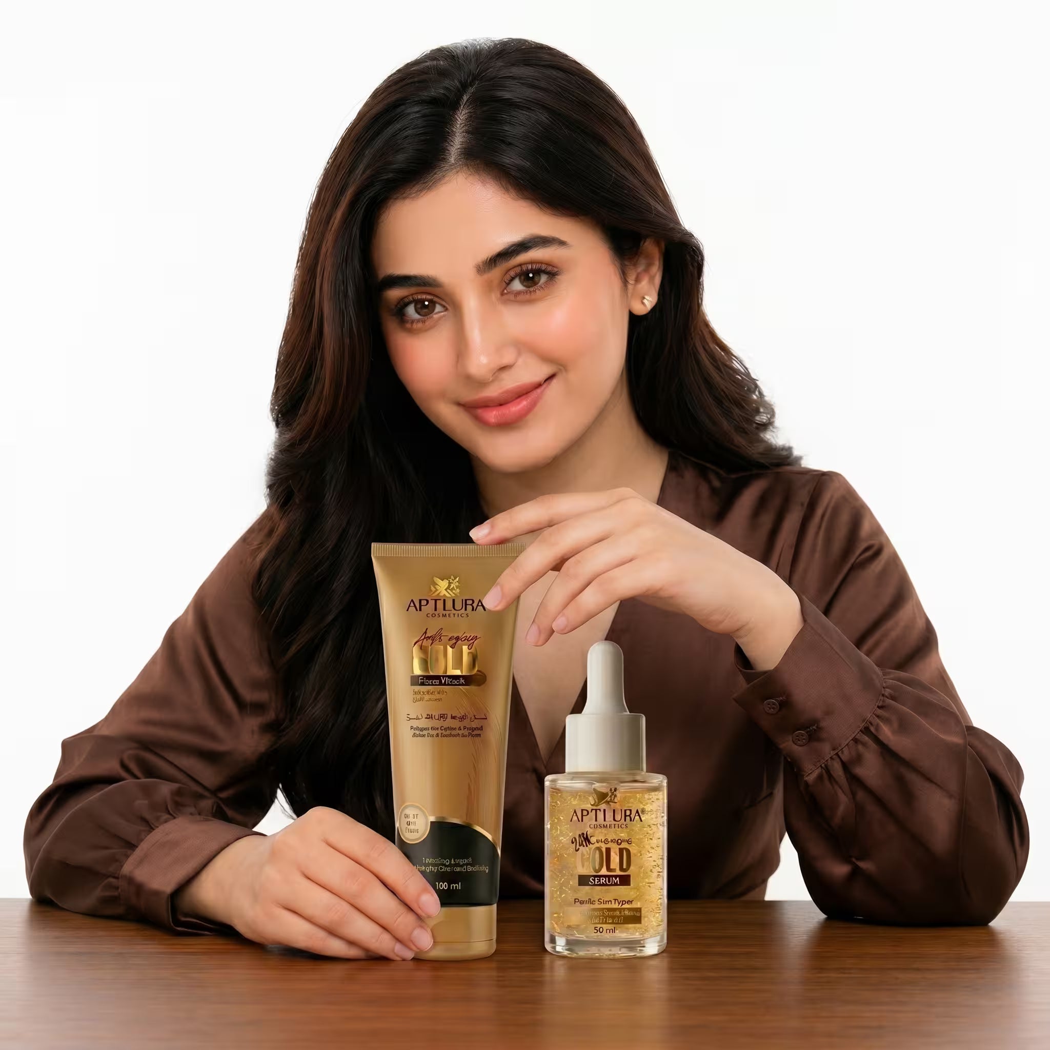 Woman holding a tube of Aptlura skincare product on a wooden table with a white background