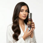 Woman holding a bottle of hair care product against a white background