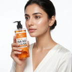 Woman holding a bottle of Citrus Hand Wash with a white background