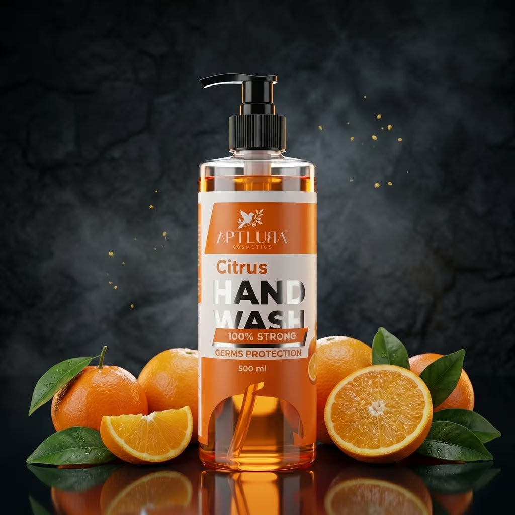 Hand wash bottle with pump dispenser surrounded by oranges on a dark background