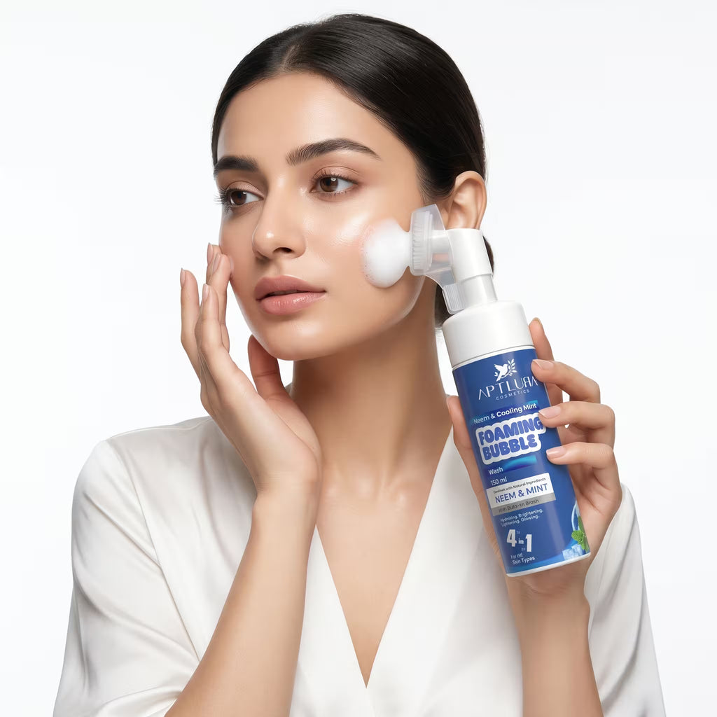 Woman applying foaming bubble cleanser to her face with a white background