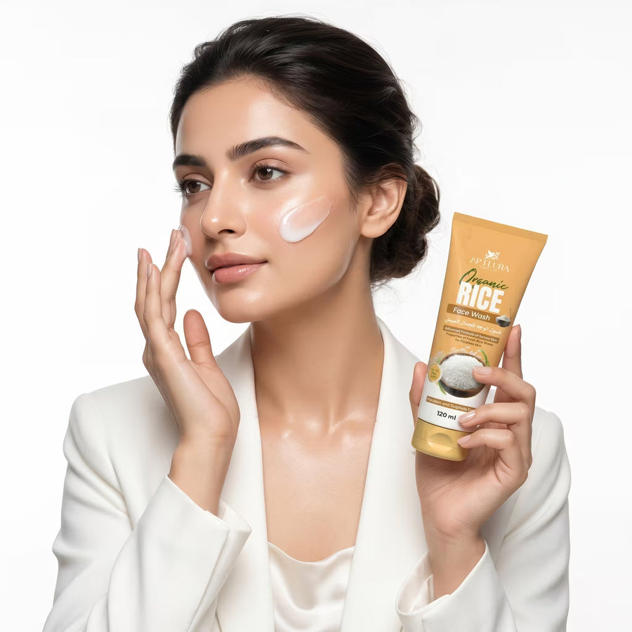 Woman applying cream to her face with a tube of Cretin Crema Rice Face Cream in the background.