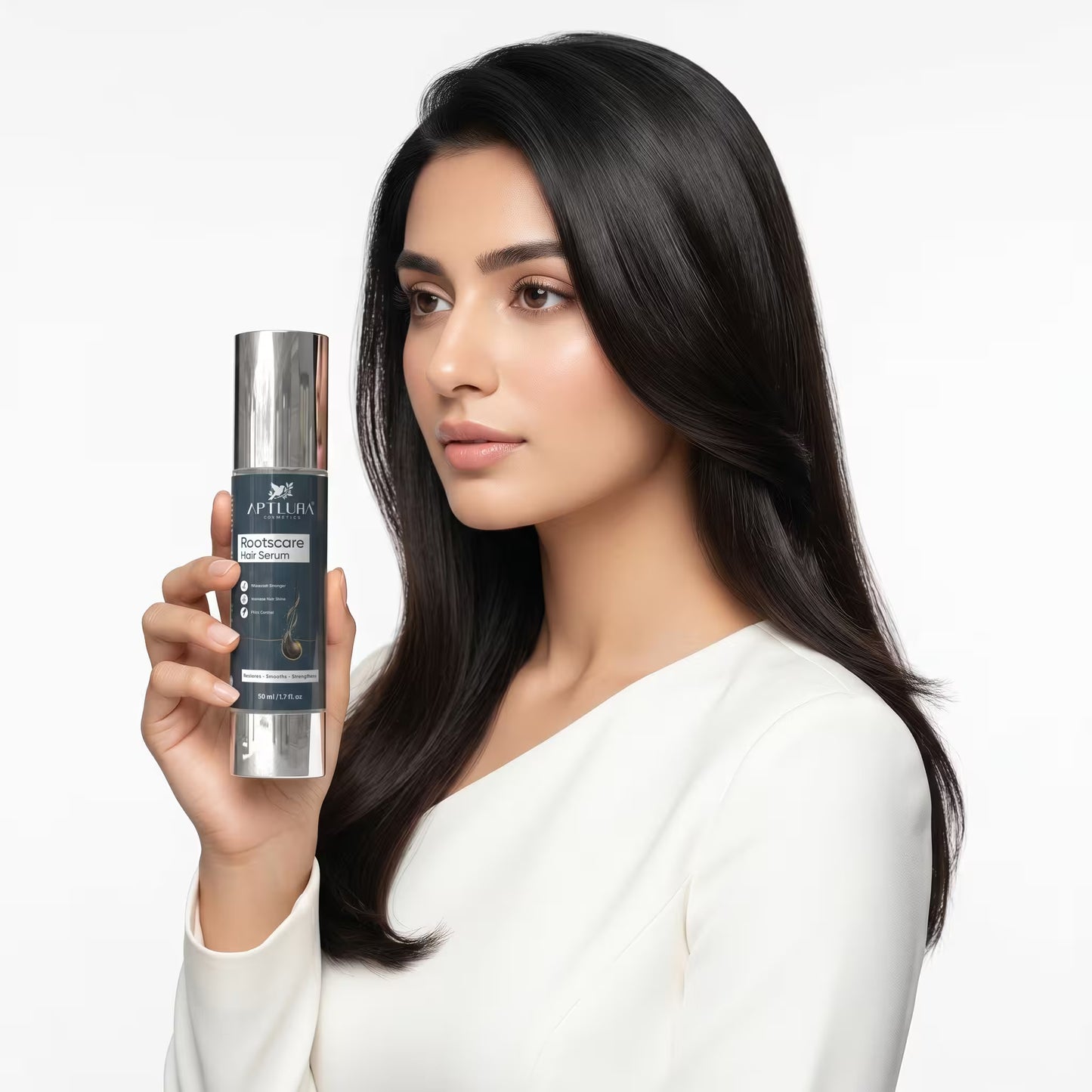 Woman holding a skincare serum bottle with a plain background