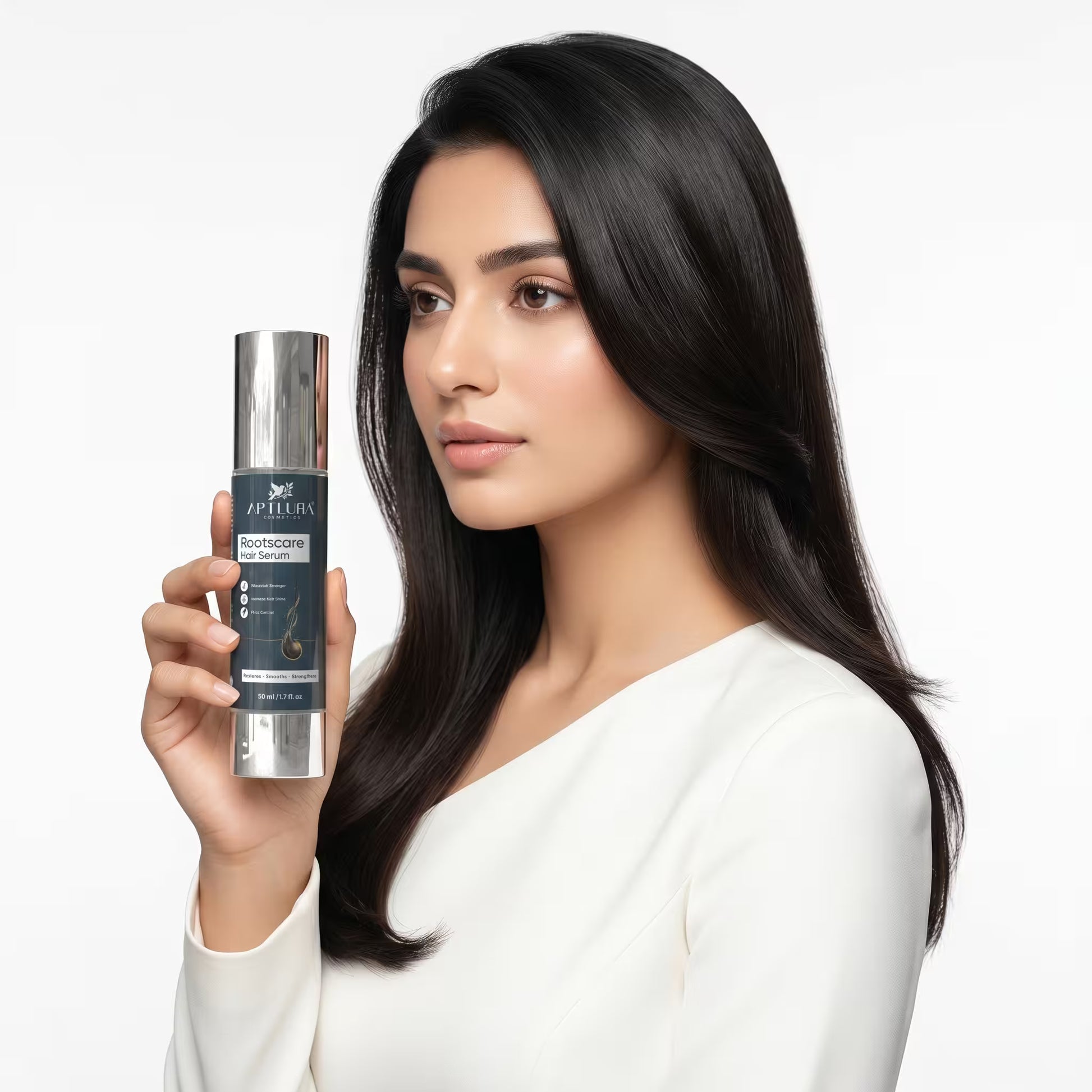 Woman holding a skincare serum bottle with a plain background