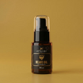 Bottle of beard oil with a brown label on a yellow background