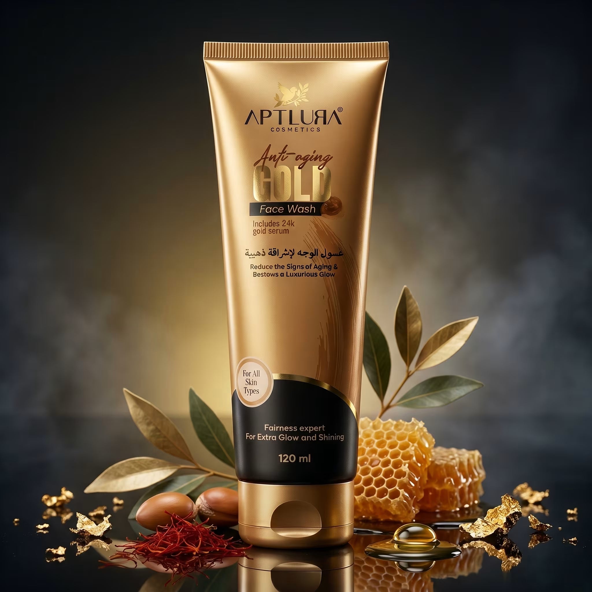 Gold tube of Aptlura Anti-Aging Face Wash with honeycomb and leaves on a reflective surface