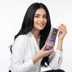 Woman holding a bottle of hair care product against a white background