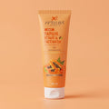 Tube of Aptlura Papaya Scrub & Facewash on an orange background