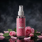 Bottle of 'Pure Rose Water' with pink roses on a dark background