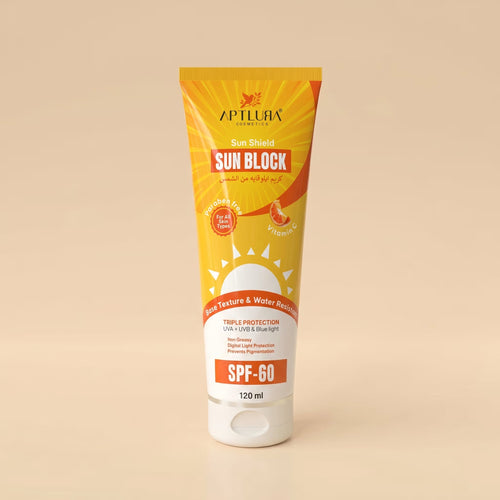 Sun block tube with yellow and white packaging on a beige background