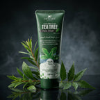 Tube of Aptlura Tea Tree Face Wash with green leaves on a dark background