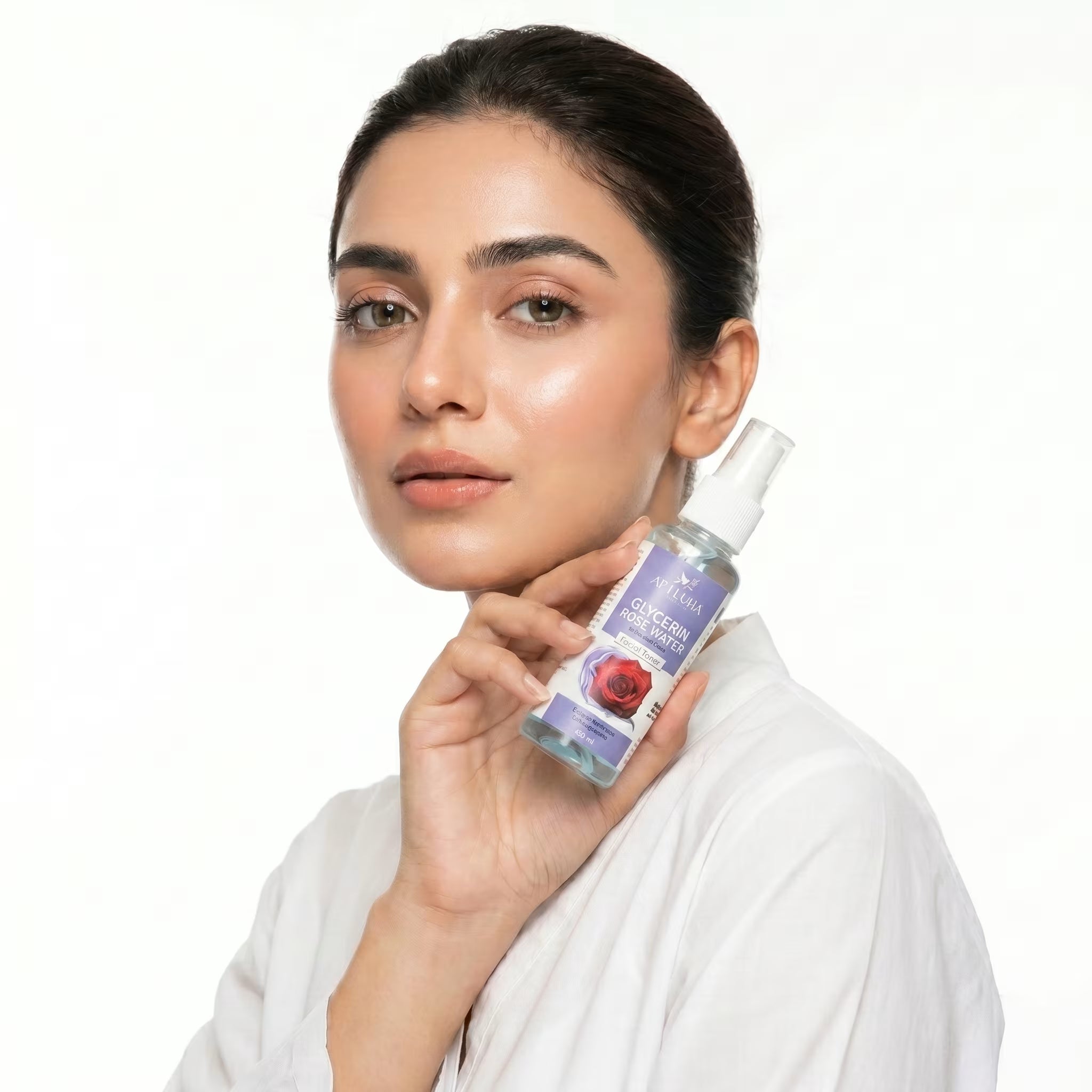 Woman holding a skincare product bottle with a white background
