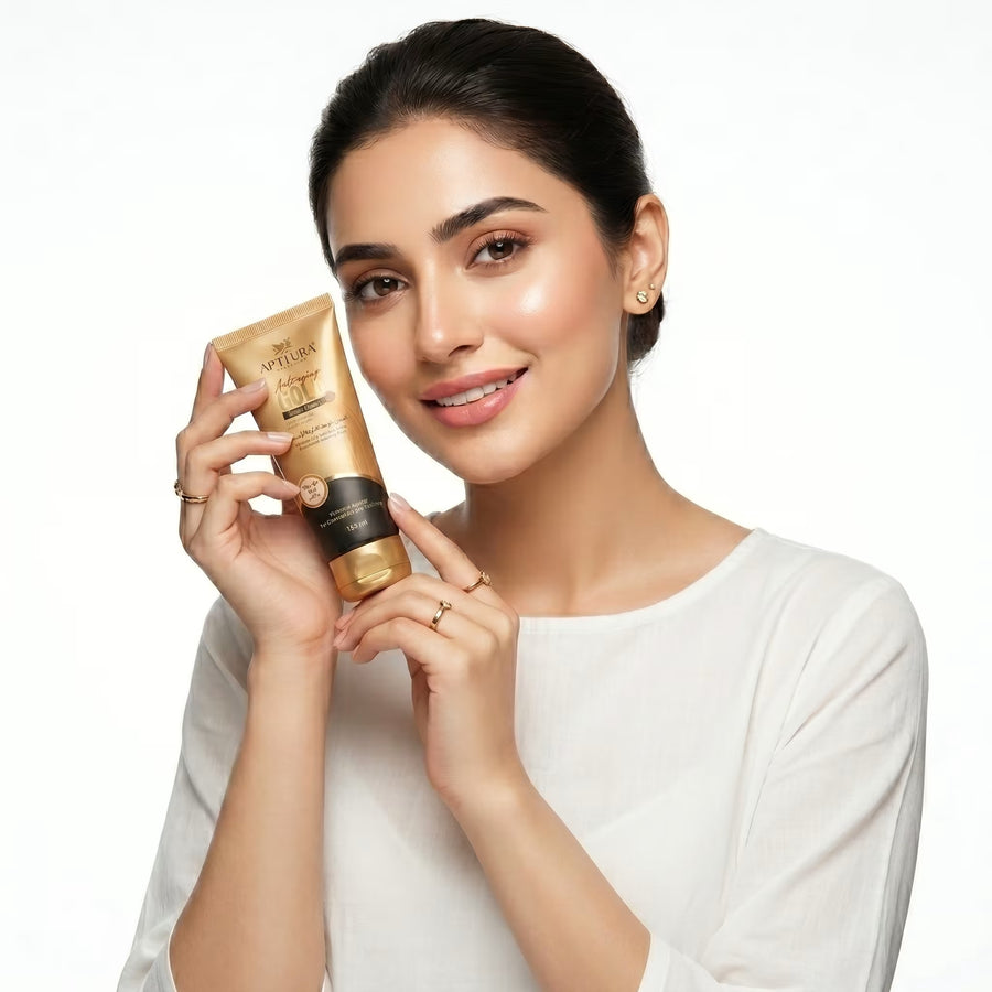 Woman holding a skincare product with a plain background