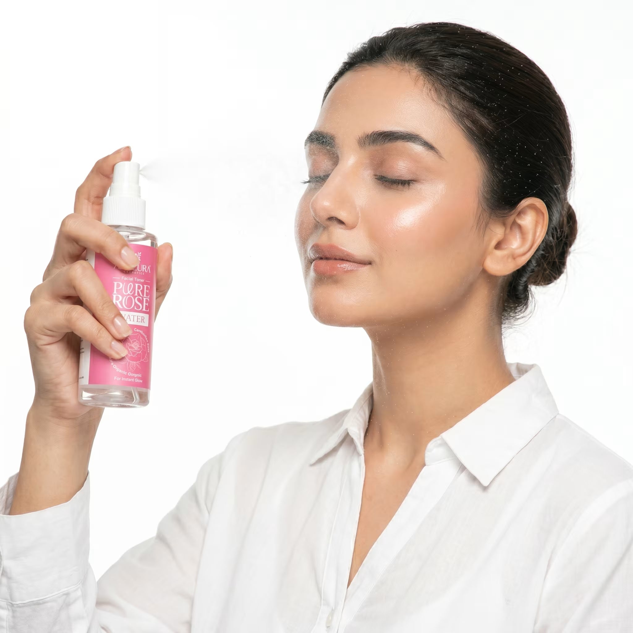 Woman holding a pink bottle of 'My Rose' product against a white background