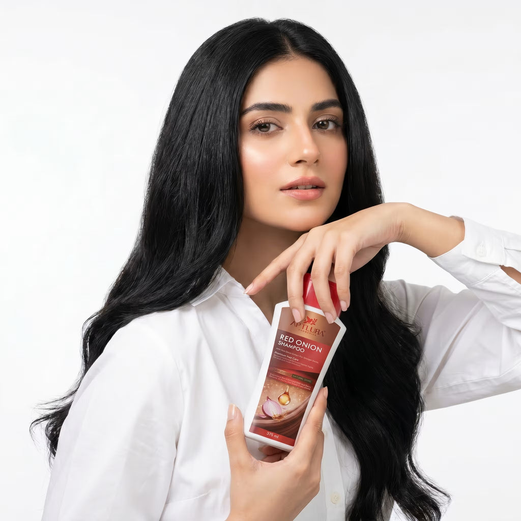 Woman holding a hair care product with a white background