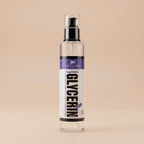 Clear spray bottle labeled 'Vegetable Glycerin' on a beige background