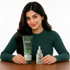 Woman holding a bottle of Aptlura Tea Tree Face Wash and serum on a wooden table.