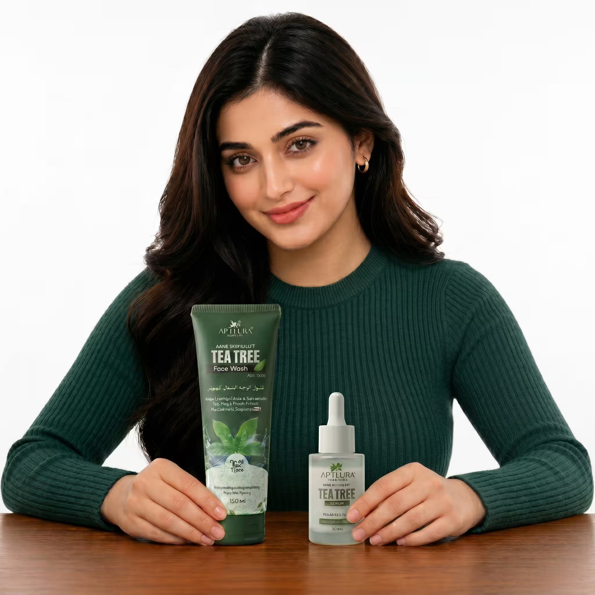 Woman holding a bottle of Aptlura Tea Tree Face Wash and serum on a wooden table.