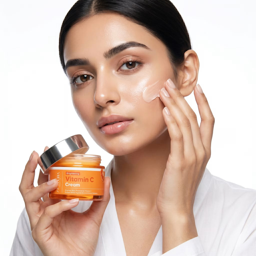 Woman applying Vitamin C cream to her face with a jar of the product in hand.