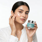 Woman applying cream to her face with a jar of Vitamin E day cream.
